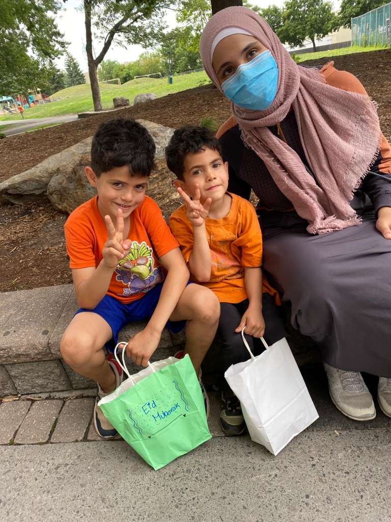 A Sidra mentor sits beside two mentees